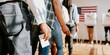 © Rawpixel.com - Diverse people in line voting in election, holding ballots. Voting in election, diverse group of people casting ballots. Diverse people voting, US election, close up photo of hand holding ballots