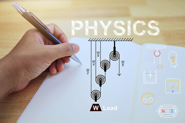 Wall Mural - learning physics concept with students' hands writing on a notebook about the pulley lesson