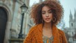 © Chinases - Stylish Woman with Curly Hair in a Textured Cardigan outdoors