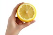 © Serhii - Bright Citrus: Female Hand Compressing Lemon Against a Clean White Background