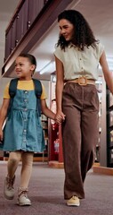 Poster - Smile, teacher and child talking in library for knowledge, studying and information for exam. Woman, girl and walking for education with books search, tutor helping and academic development at school