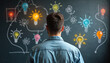 © Vadym - Back view of man looking at light bulbs on blackboard. Concept of creative thinking innovative idea generation. Concept of business solution brainstorming. New tech concepts for company development.