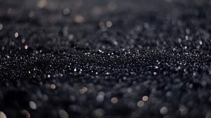 Sparkling black sand beach sunset bokeh background texture