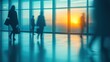 © Egriva - Office workers walking sunset cityscape lobby