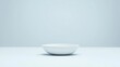 © CoreVisuals - A simple, minimalistic white bowl sits on a pale background, creating a serene and modern aesthetic.