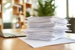 © SUPHANSA - A sleek desk with neatly stacked business documents and a laptop, soft lighting, neutral background,