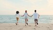 © sorapop - Happy friends holding hands running enjoy life funny and freedom on sand at beach together to sea in holiday vacation time at sunset, Young Asian group woman and man in summer travel, people lifestyle