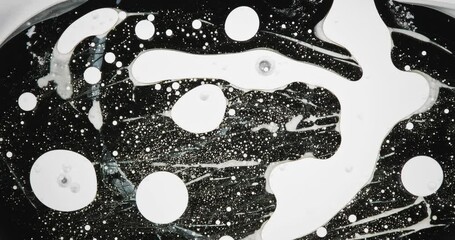 Wall Mural - black and white alcohol ink is creating abstract patterns on a white background, forming an interest