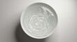 © AnilaStudio - Bowl of water with ripples on white background