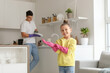 © Pixel-Shot - Cute little girl with rubber gloves and her father in kitchen