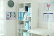 © New Africa - Blurred view of shelving unit in doctor's office