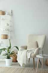 Poster - Stylish furniture, houseplant and decor near white wall