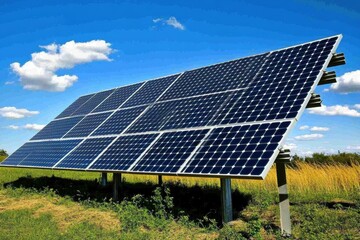 Solar panel array in sunny landscape with blue sky and clouds