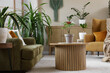 © Pixel-Shot - Interior of living room with green houseplants, sofa and armchair