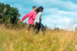 © YesPhotographers - Gen Z couple holding hands and enjoying nature on a sunny day