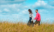 © YesPhotographers - Young couple holding hands and enjoying nature under the blue sky