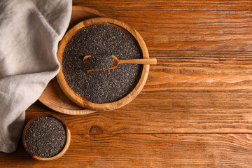 Wall Mural - Bowl and plate with chia seeds on wooden background