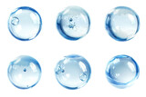 Collection of transparent soap bubbles with soft reflections gently floating on a clean white background