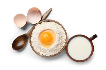 Wall Mural - plate with flour, raw chicken egg, spoon and cup of milk on white background