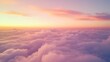 © locomo - Flying above a dense layer of clouds at sunset reveals a spectacular view of the colorful sky painted in shades of orange, pink, and purple over the vast cloudscape.