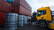 © Maksym Tereshchenko - Industrial warehouse with galvanized steel coils being loaded into shipping containers, highlighting the logistics and machinery involved in metal distribution