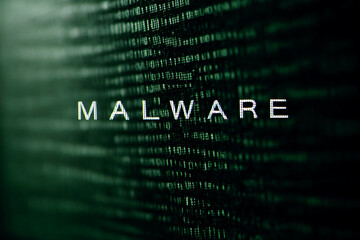 green digital code background with the word malware displayed prominently, symbolizing cybersecurity