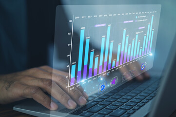 Wall Mural - business professional analyzing interactive digital bar charts to monitor performance metrics and dr