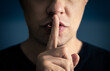© terovesalainen - Quiet and silence! Secret of a man. Hush. Finger and mouth. Shh. Silent confidential gesture. Lips sealed. Freedom of speech, censorship, taboo or gossip concept.