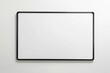 © Roshani - A blank whiteboard with a black frame hangs on a white wall, ready for notes or ideas.