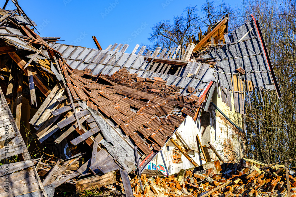 Collapse Rusted Building Old building ruins show significant collapse and damage in bright ...