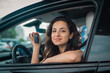 © Nataliya - Happy Caucasian female car driver showing new car keys while sitting at driver seat. Lifestyle, transportation, sale, ownership concept
