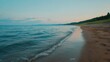 © Suroart - Sandy beach, calm water, evening sky, distant land.