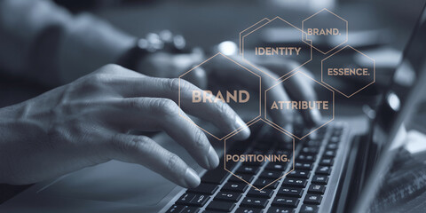 Wall Mural - close-up of hands typing on a laptop keyboard, overlaid with brand identity hexagons highlighting co