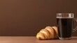 © JK_kyoto - Fresh coffee and croissant on wooden table with brown background