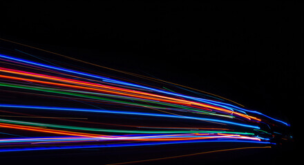 Wall Mural - abstract image of colorful light streaks against a dark background in a horizontal pattern