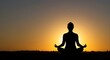 © Pambudi - Silhouette of a person meditating in a yoga pose during sunrise, symbolizing inner peace, mindfulness, and spiritual balance in a calm natural setting.