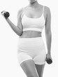 © Dimid - Slim, bodybuilder girl, lifts heavy dumbbell on a white background. Sports concept, fat burning and a healthy lifestyle.