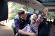 © Davor - Father securing daughter in car seat before family road trip