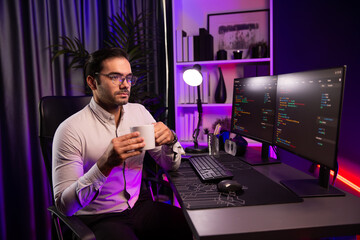 Wall Mural - smart it developer drinking coffee cup while working in software development coding on pc screen, pr