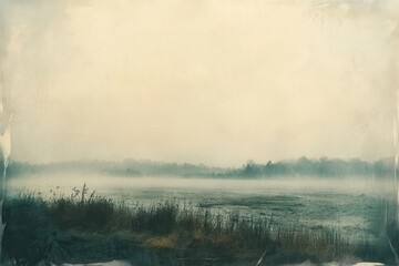 Poster - Misty dirt road stretching through quiet fields at dawn with soft light illuminating a tranquil landscape