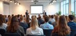 © Viktor - Audience view conference room. People listen presentation. Pro event, modern decor. Scandinavian design style interior. Presentation screen, speaker. Business event, seminar. Crowd watching speaker.