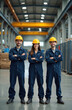 © Viktor - Group workers in industrial factory. Team of men women wearing hard hats, blue work uniforms. Smiling faces looking camera, arms crossed. Manufacturing, industry, teamwork concept. Collaboration,