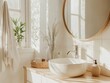 © Bouchra - A bathroom with a white sink and a mirror. A towel is hanging on the window. A basket is on the counter next to the sink