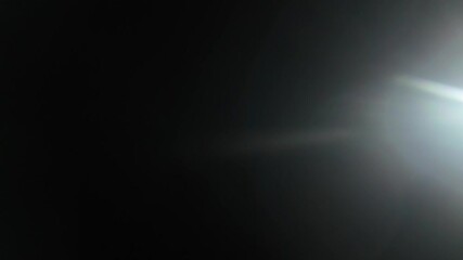 Wall Mural - beautiful abstract defocused highlight on a dark background. real light leaks and glare.