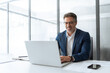 © Stock 4 You - Mature Indian or Latin hispanic business man ceo manager using laptop computer typing in modern office. Middle eastern smiling senior businessman entrepreneur sitting at desk working on pc. Copy space