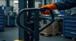 © erinWorks - Close-up of Pallet Truck Handle and Hydraulic Pump in Factory