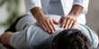 © aciddreamStudio - Chiropractor performs spinal adjustment for a patient in a bright clinic environment