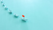 © tomertu - Paper boats following ahead of the leader with red flag