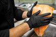 © pavel siamionov - A chef in black gloves carefully handles a large piece of salmon, preparing it for cooking. The focused attention showcases the precision and skill involved in seafood preparation.