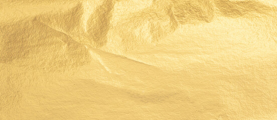 Fototapete - Gold metallic foil texture with a crumpled, smooth surface. Shiny, bright material in warm yellow tones, featuring an elegant gradient and subtle shimmer. Premium design with a rich, luxurious look,.